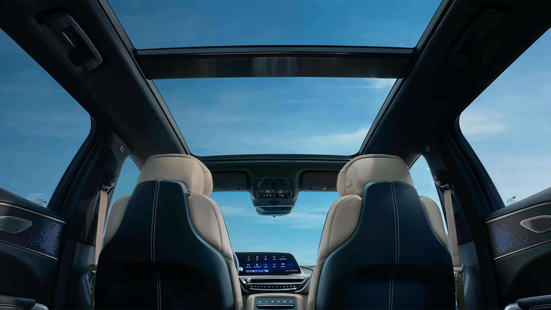 2026 Cadillac LYRIQ interior with SkyGlass roof, two-tone front seats, ambient lighting, and digital display