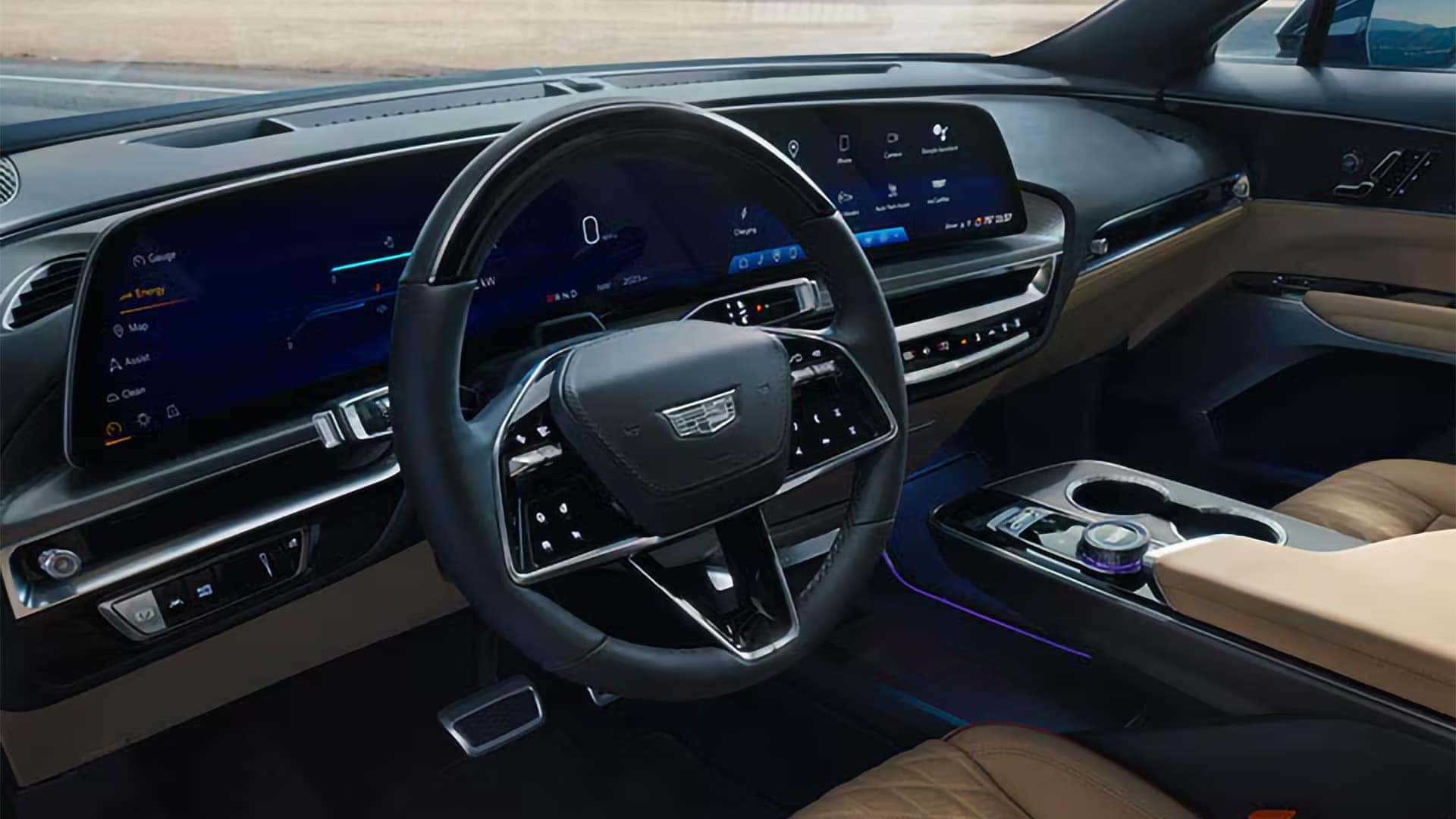 2026 Cadillac LYRIQ cockpit with 33-inch display, steering wheel controls, center console, and ambient interior lighting