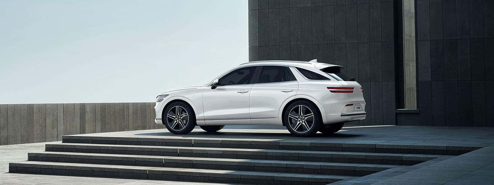 2026 Genesis Electrified GV70 white luxury electric SUV parked outside a modern building