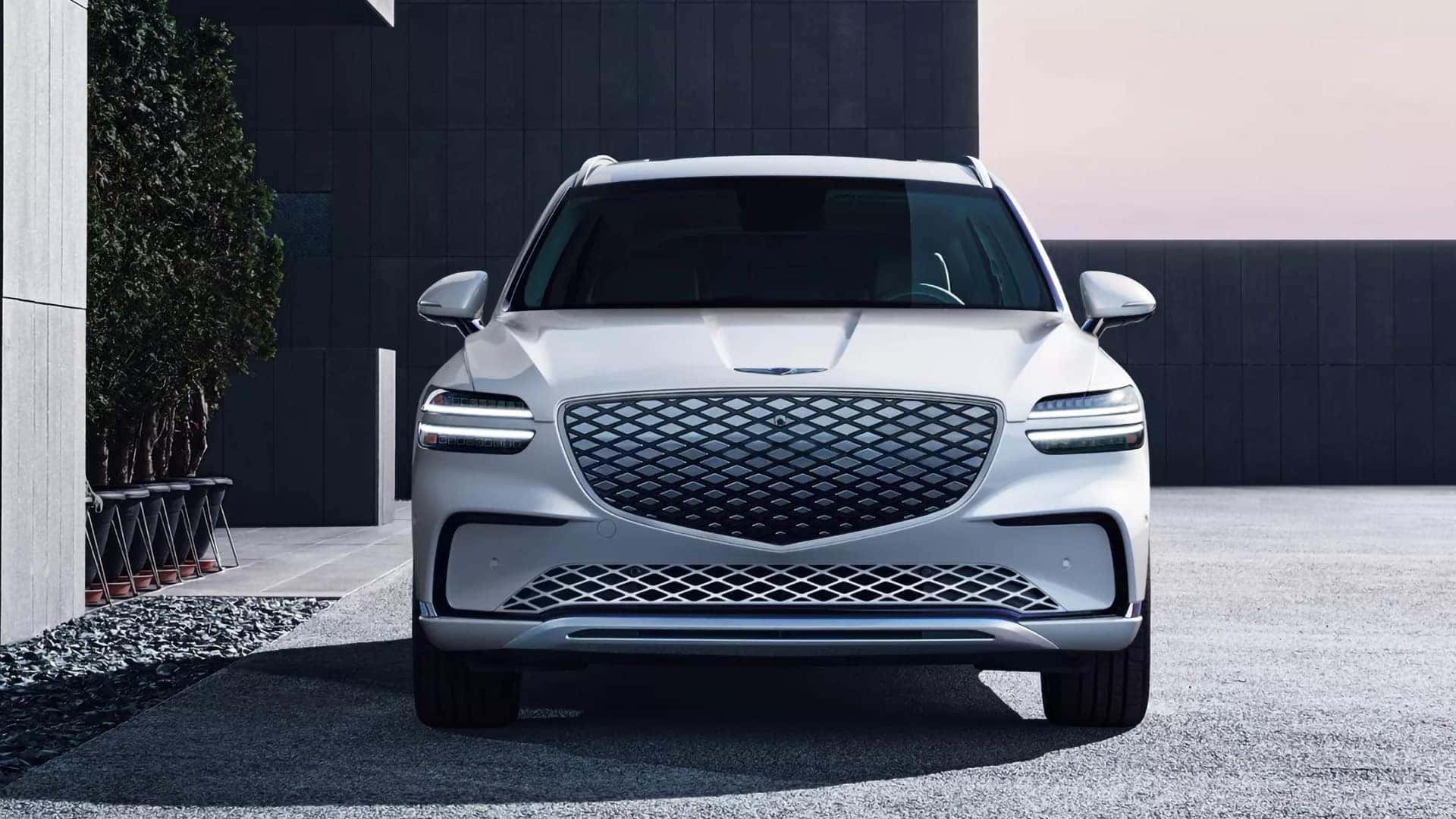 Front view of a white 2026 Genesis Electrified GV70 displaying its G-Matrix Crest Grille and Two-Line headlights