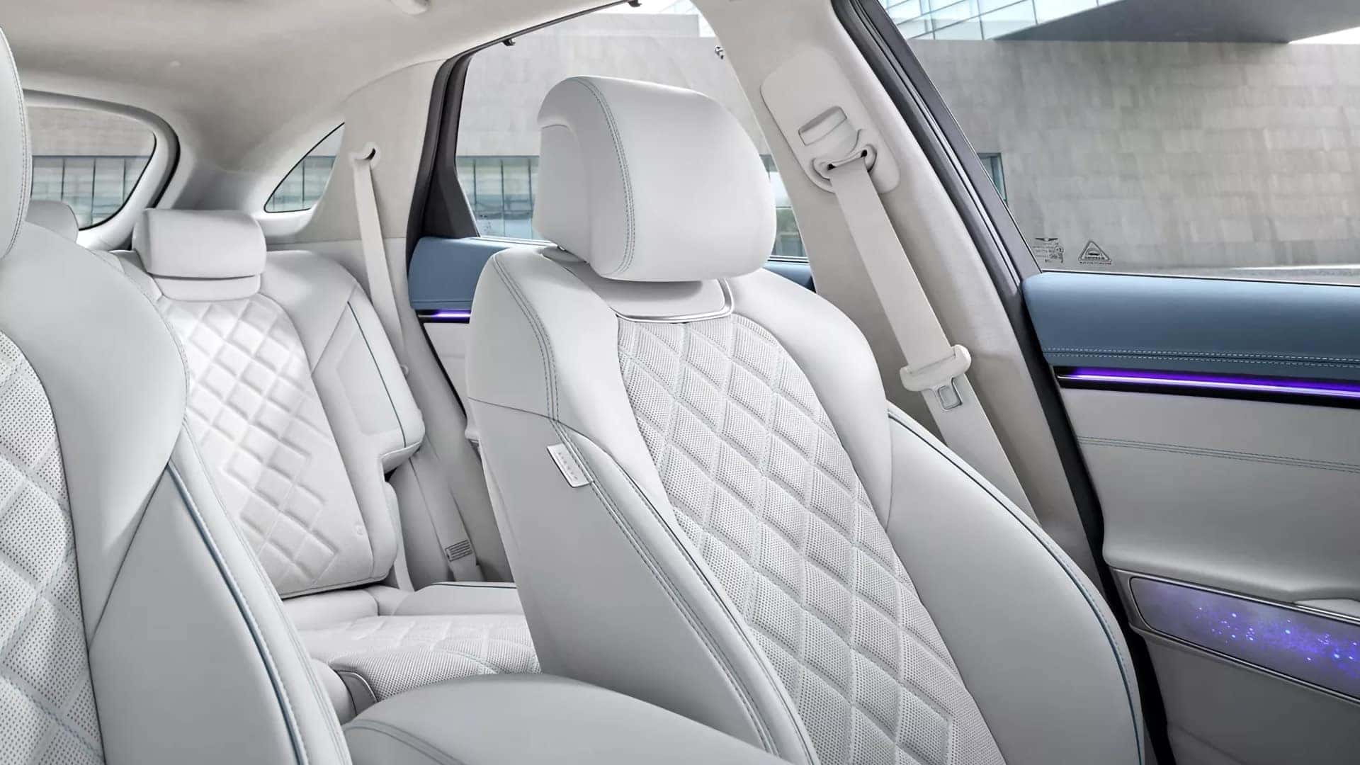 2026 Genesis Electrified GV70 interior with quilted white seats and ambient lighting