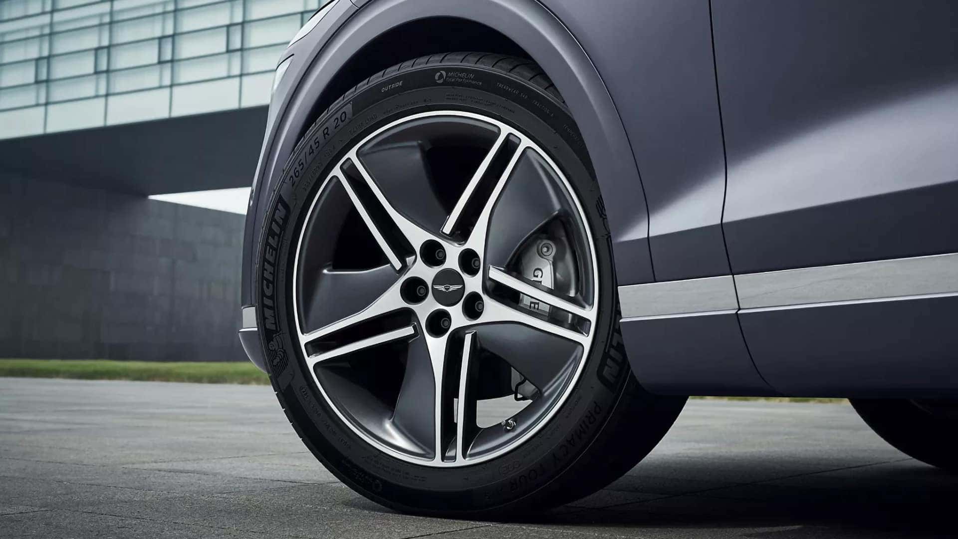 Close-up of a 20-inch alloy wheel and brake caliper on the 2026 Genesis Electrified GV70