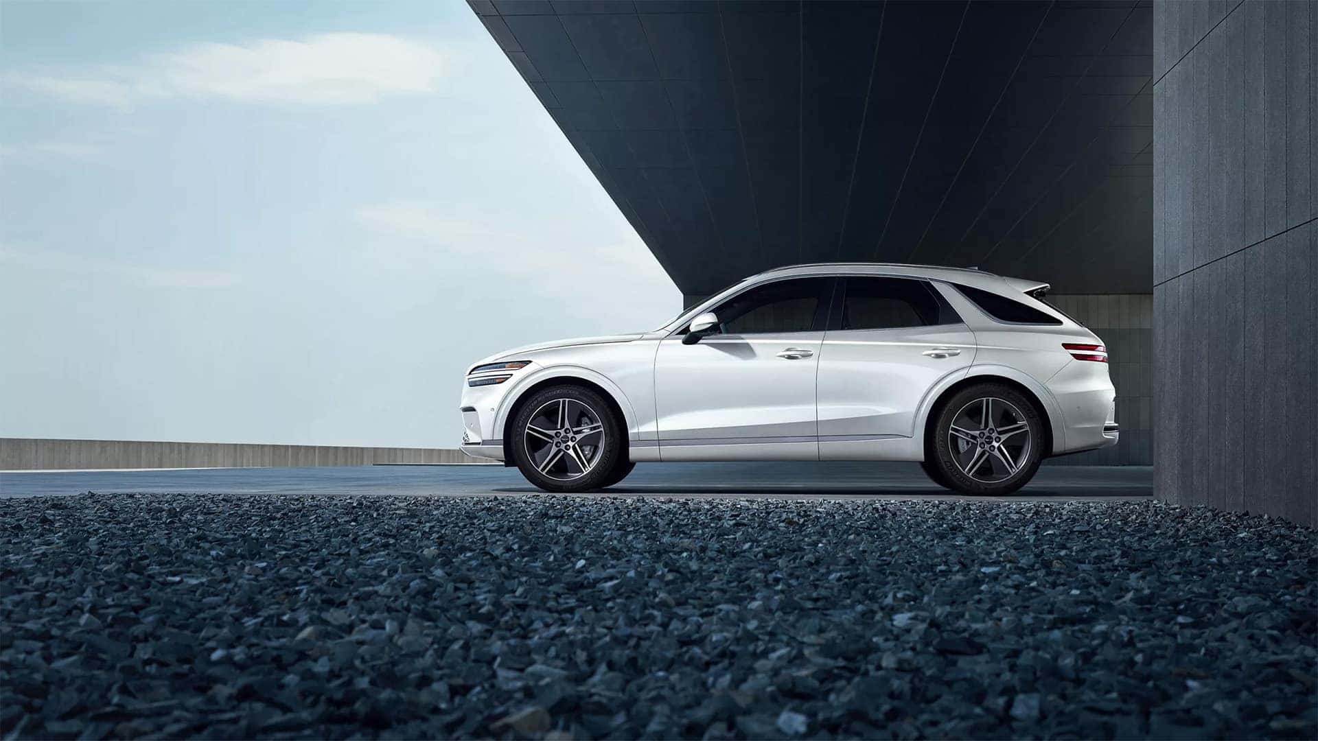 2026 Genesis Electrified GV70 side profile showing white exterior and luxury SUV design