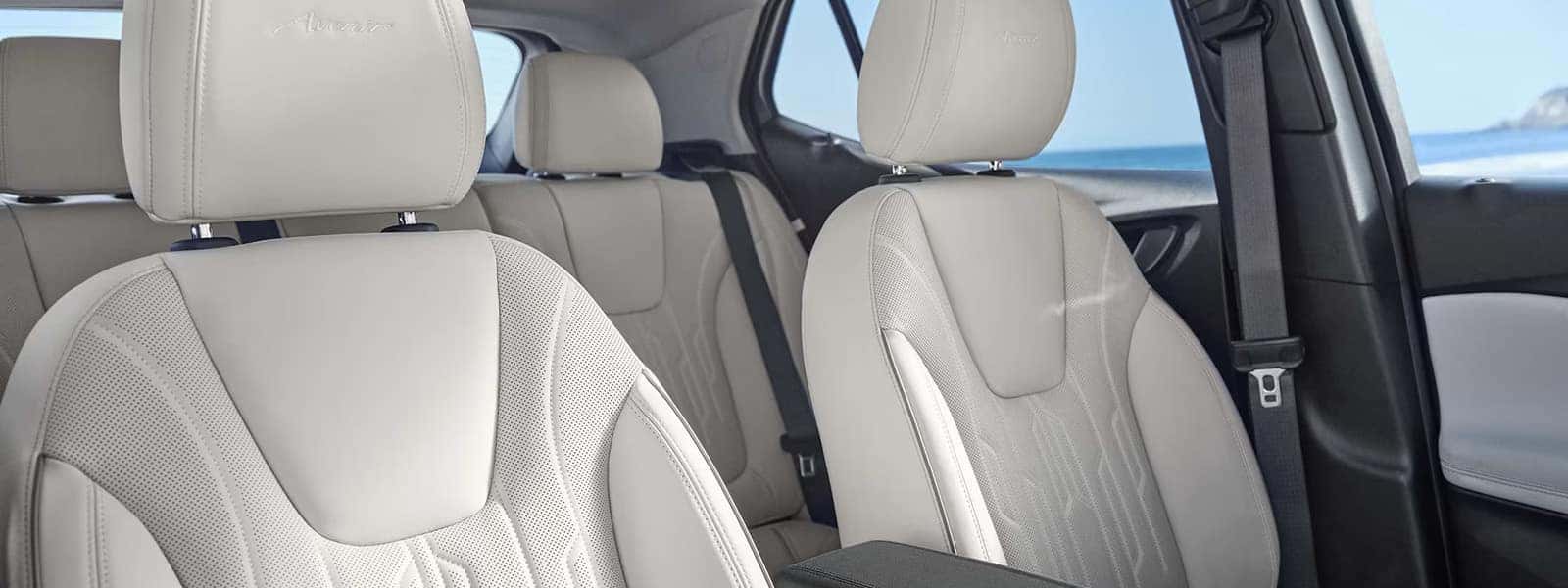 Light-colored perforated Avenir front and rear seats in the 2026 Buick Encore GX interior