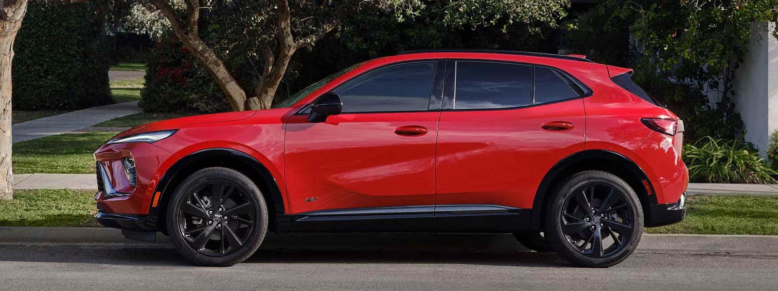 Red 2026 Buick Envision Sport Touring in side profile with black alloy wheels and sculpted body lines