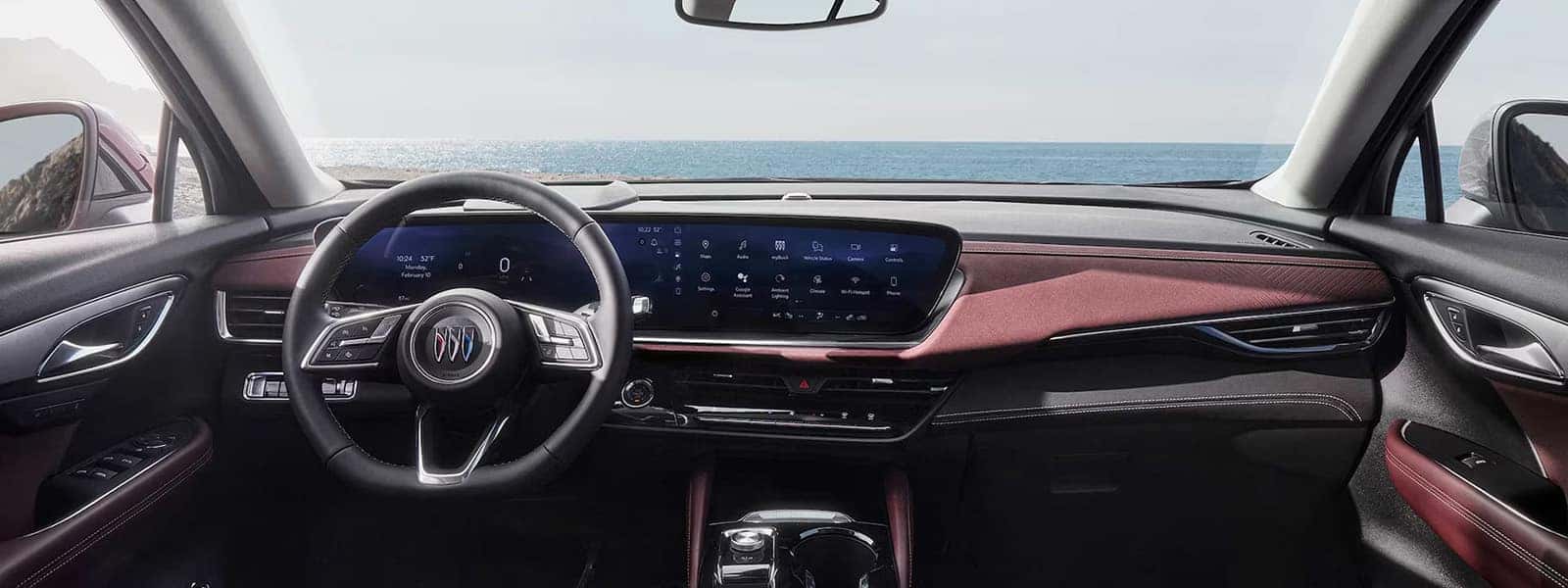 2026 Buick Envision interior with ultrawide 30-inch diagonal display, burgundy dashboard trim, and center console