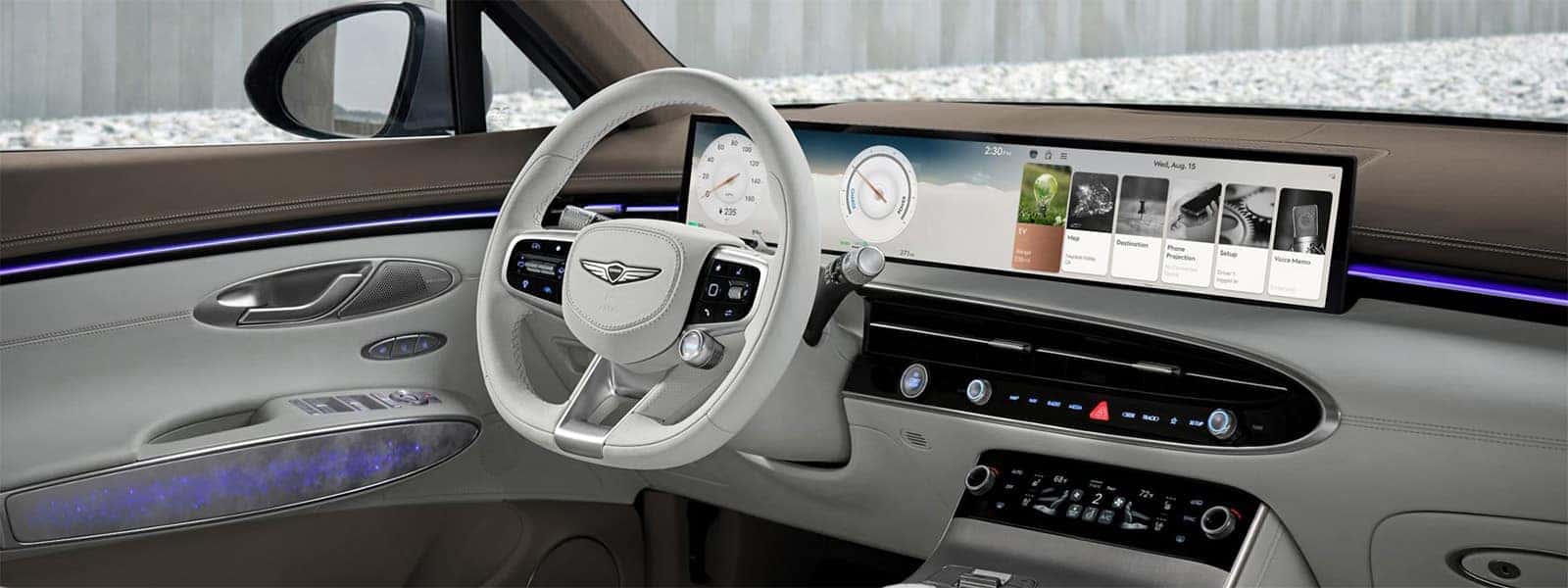 2026 Genesis Electrified GV70 cockpit with 27-inch OLED display, ambient lighting, white steering wheel, and digital controls