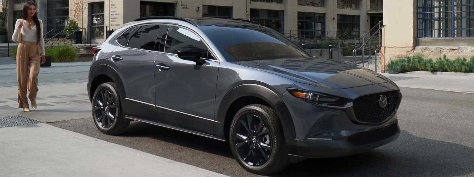 Gray 2026 Mazda CX-30 parked on a city street, shown from the front three-quarter angle