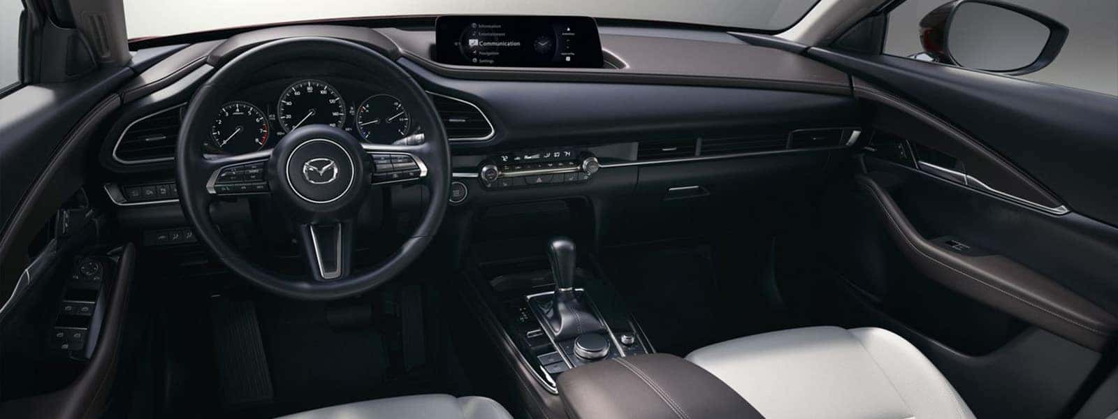 2026 Mazda CX-30 interior with steering wheel, digital gauges, center display, and front seating