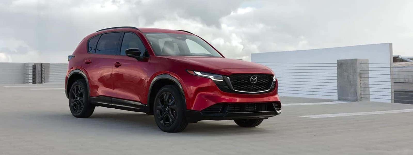 Red 2026 Mazda CX-5 shown from the front three-quarter angle on a rooftop parking deck