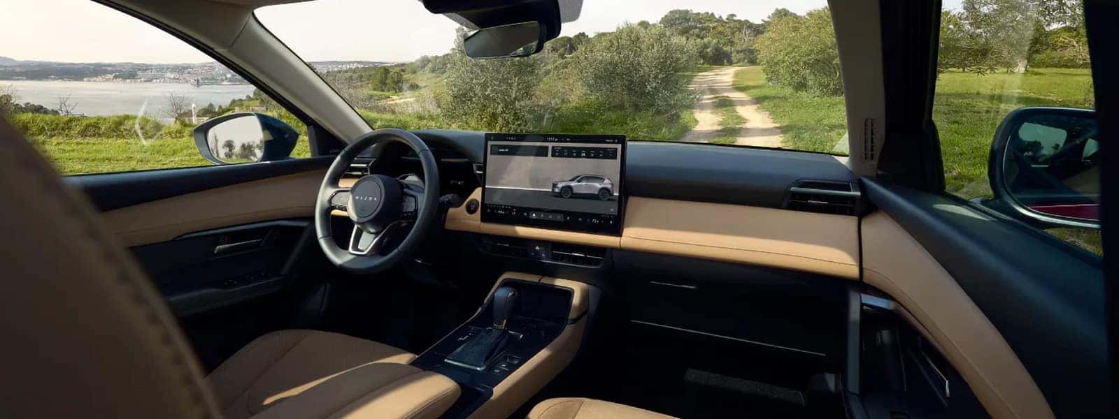 2026 Mazda CX-5 front cabin with two-tone dashboard, steering wheel, center touchscreen, and scenic view