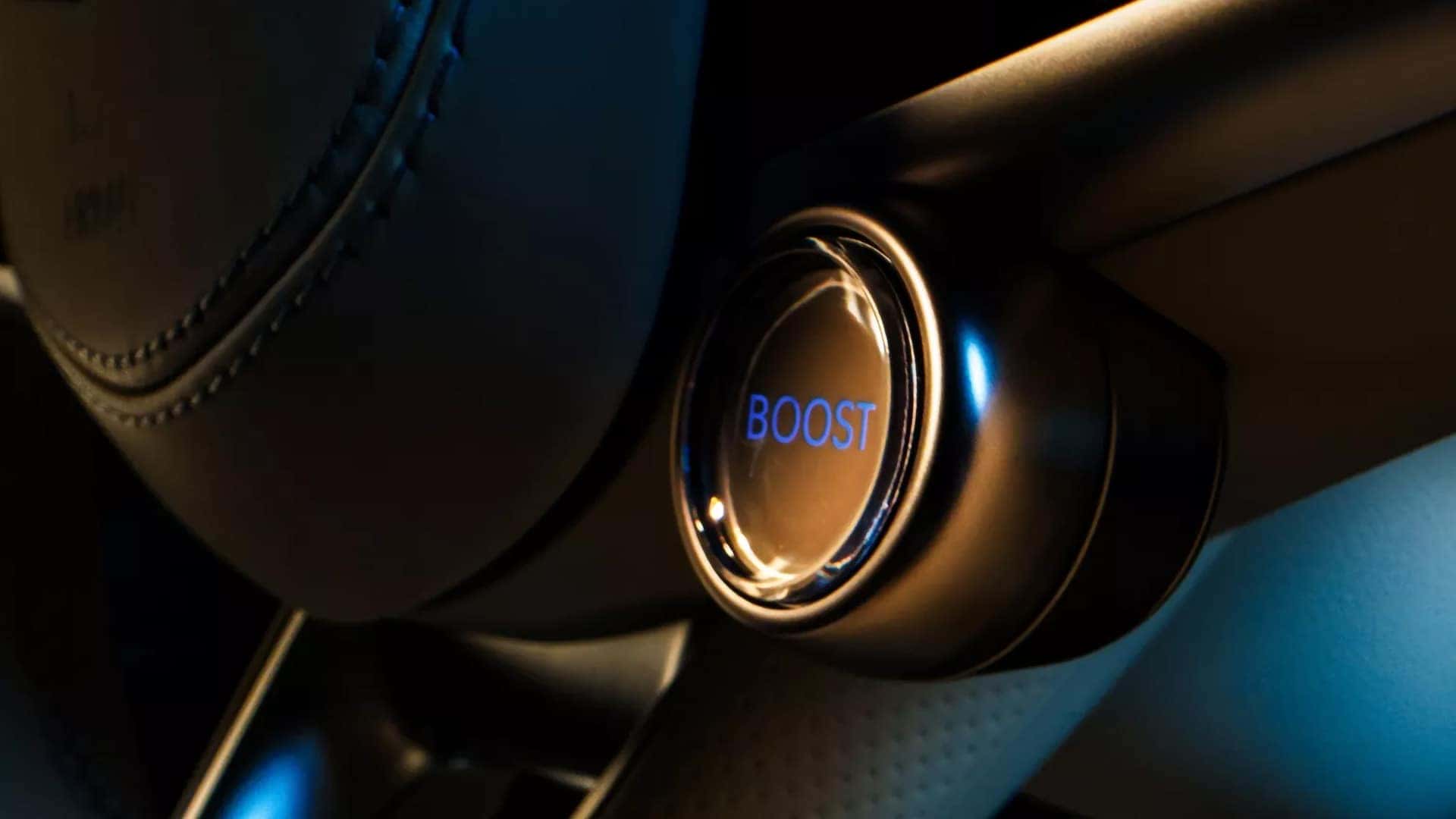 Illuminated Boost Mode button beside the steering wheel in the 2026 Genesis Electrified GV70 interior