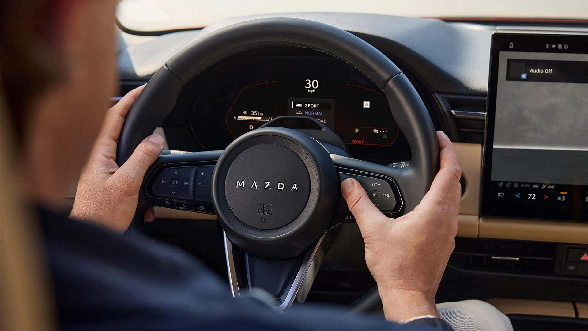 2026 Mazda CX-5 steering wheel and digital gauge cluster displaying Sport drive mode