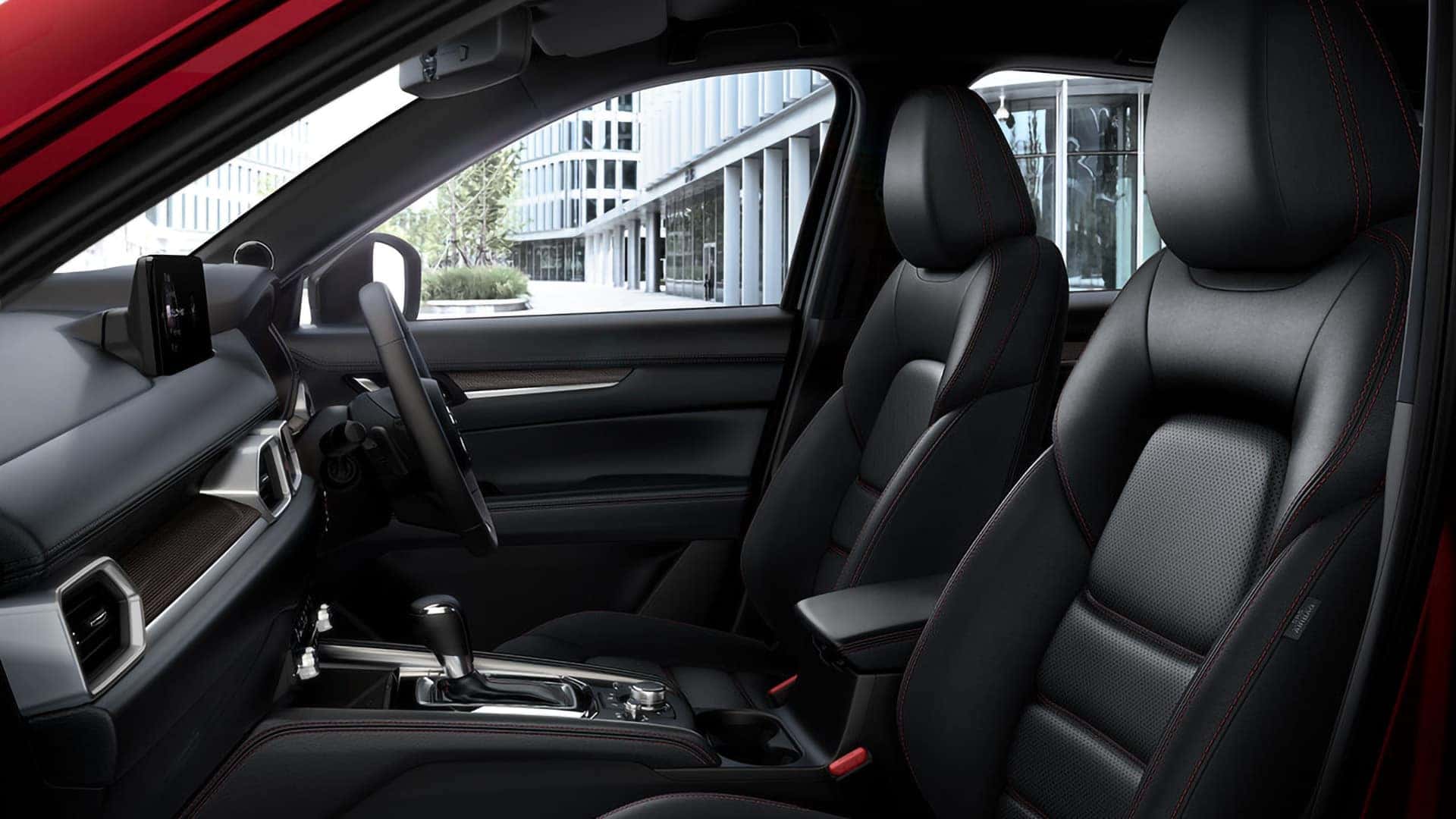 2026 Mazda CX-5 front cabin with black seats, red stitching, dashboard, and center console