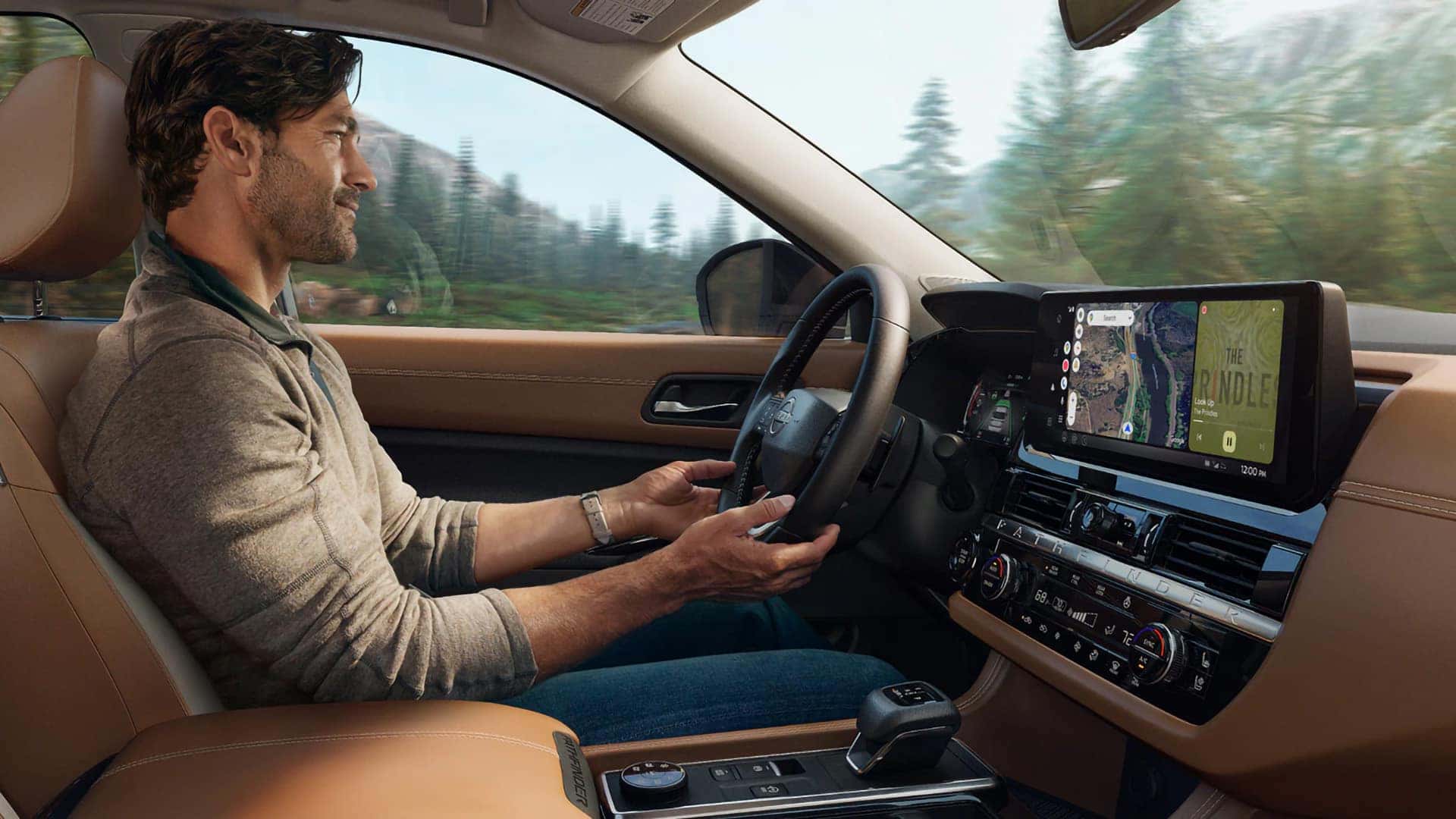 Driver inside the 2026 Nissan Pathfinder with brown seating, digital dashboard, and navigation touchscreen
