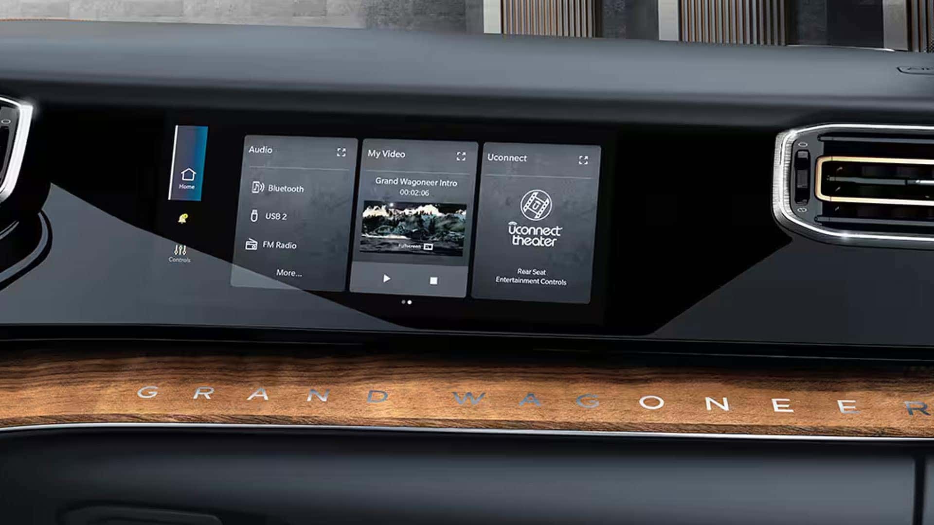 Close-up of the front passenger display, wood trim, and air vent inside a 2026 Jeep Grand Wagoneer.