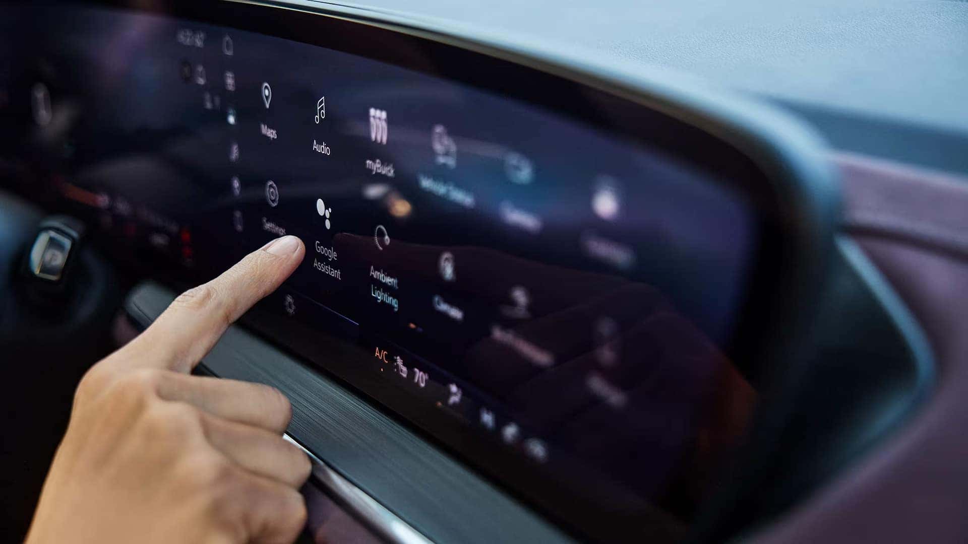 Driver selecting Google Assistant on the 2026 Buick Envision infotainment touchscreen