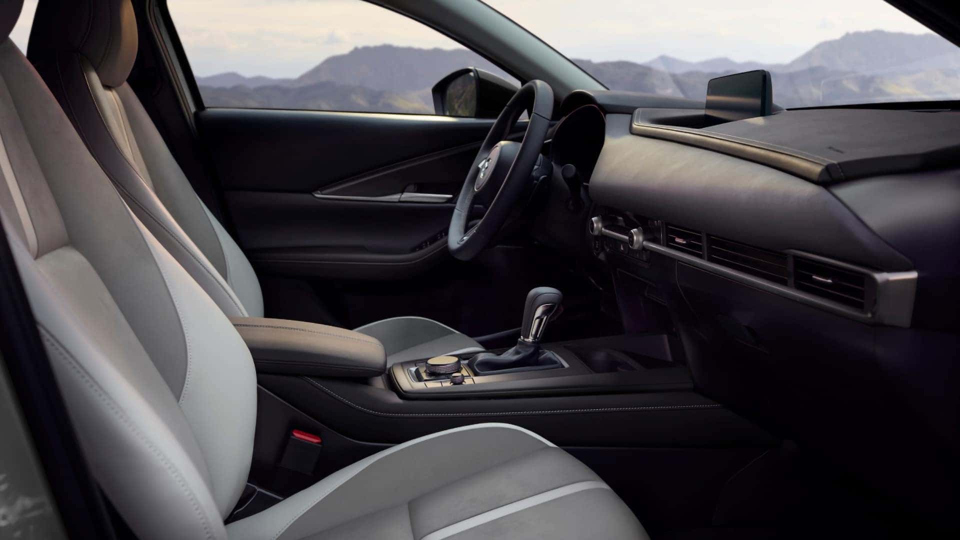 2026 Mazda CX-30 interior with white front seats, center display, and driver-focused controls
