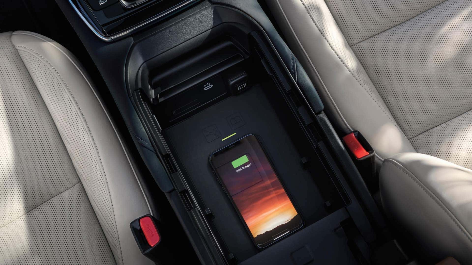 Smartphone charging on the wireless charging pad inside the 2026 Mazda CX-30
