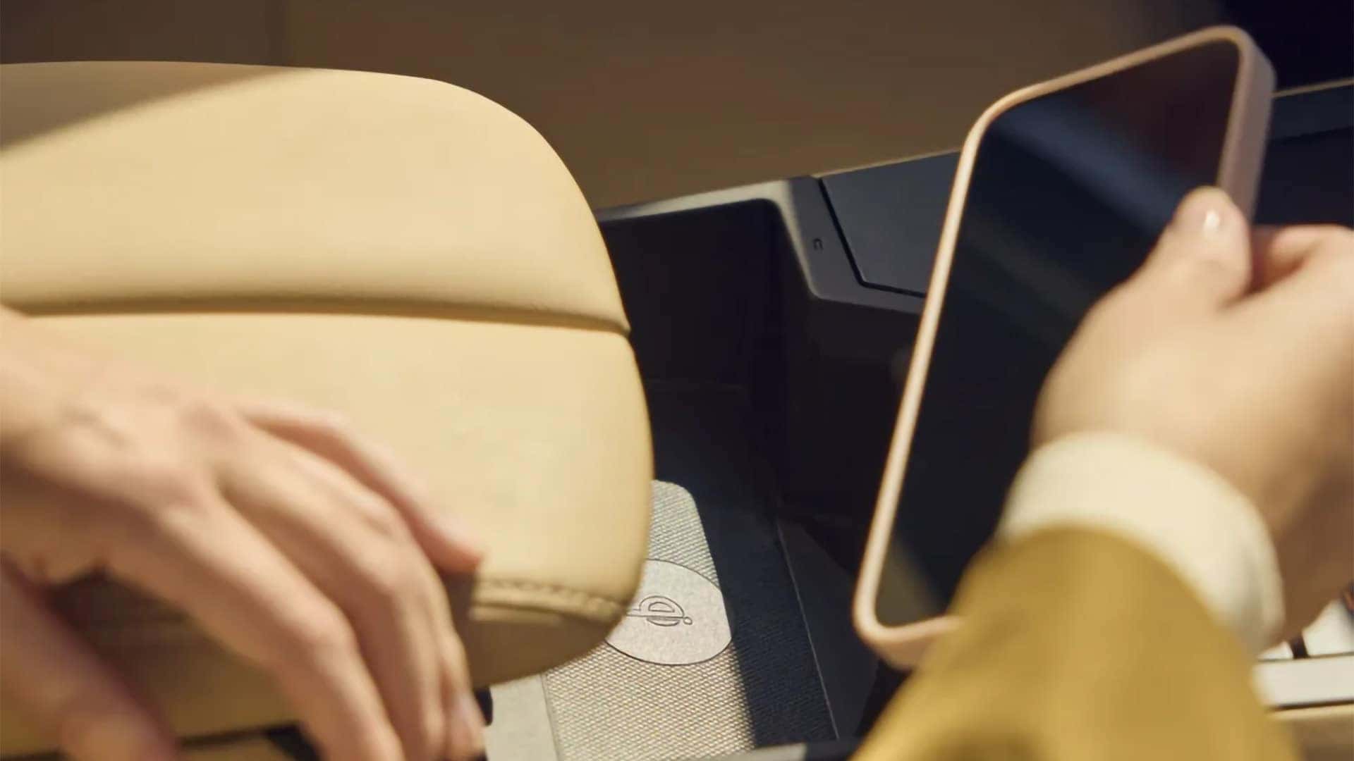Smartphone placed on the wireless charging pad inside the 2026 Mazda CX-5