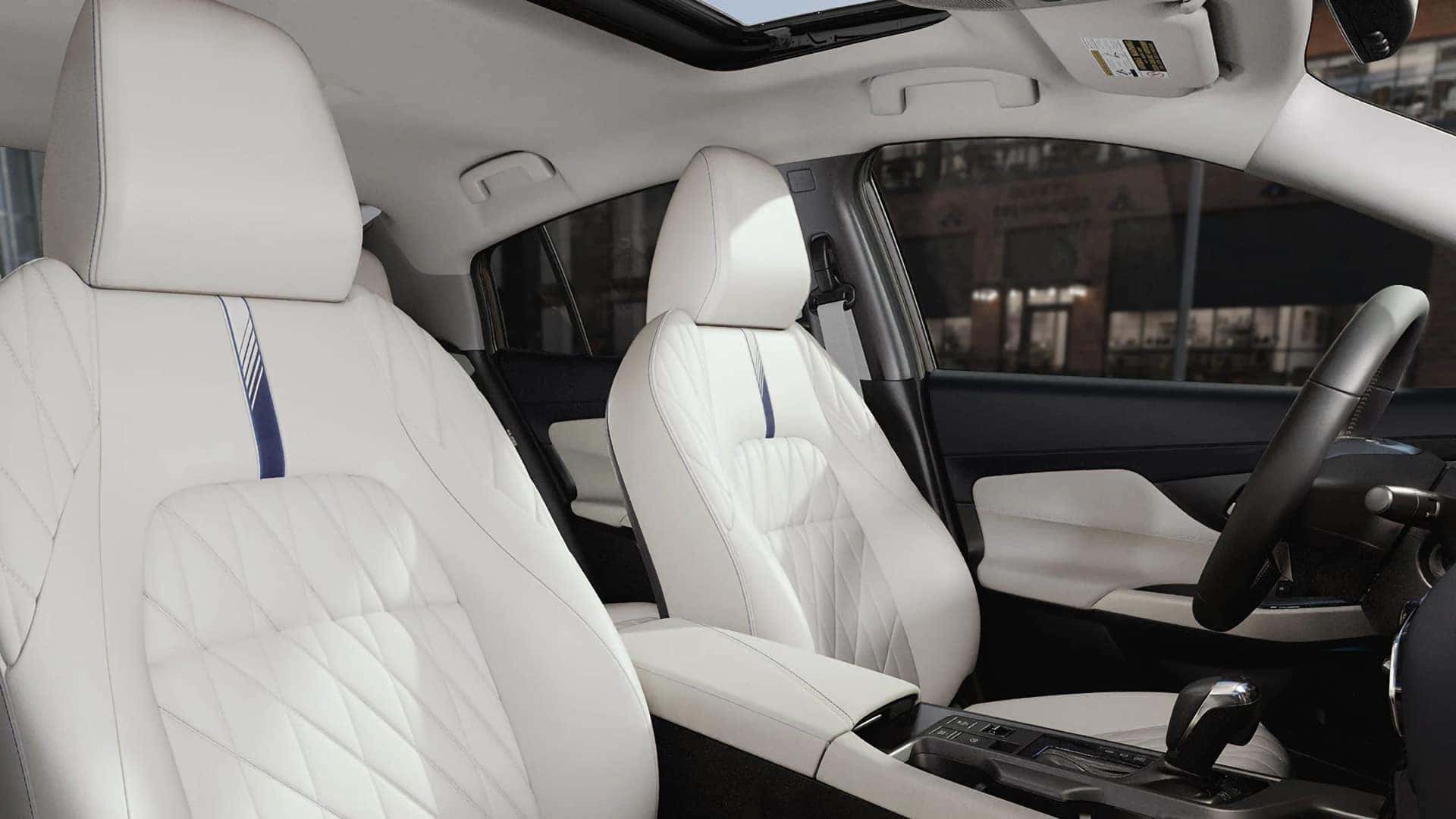 2026 Nissan Sentra interior with quilted white front seats, center console, and available moonroof.