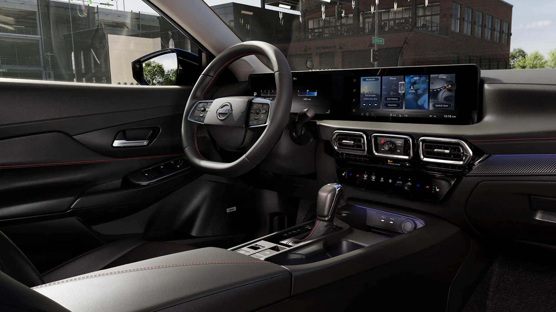 2026 Nissan Sentra cockpit with steering wheel, digital driver display, infotainment touchscreen, and center console
