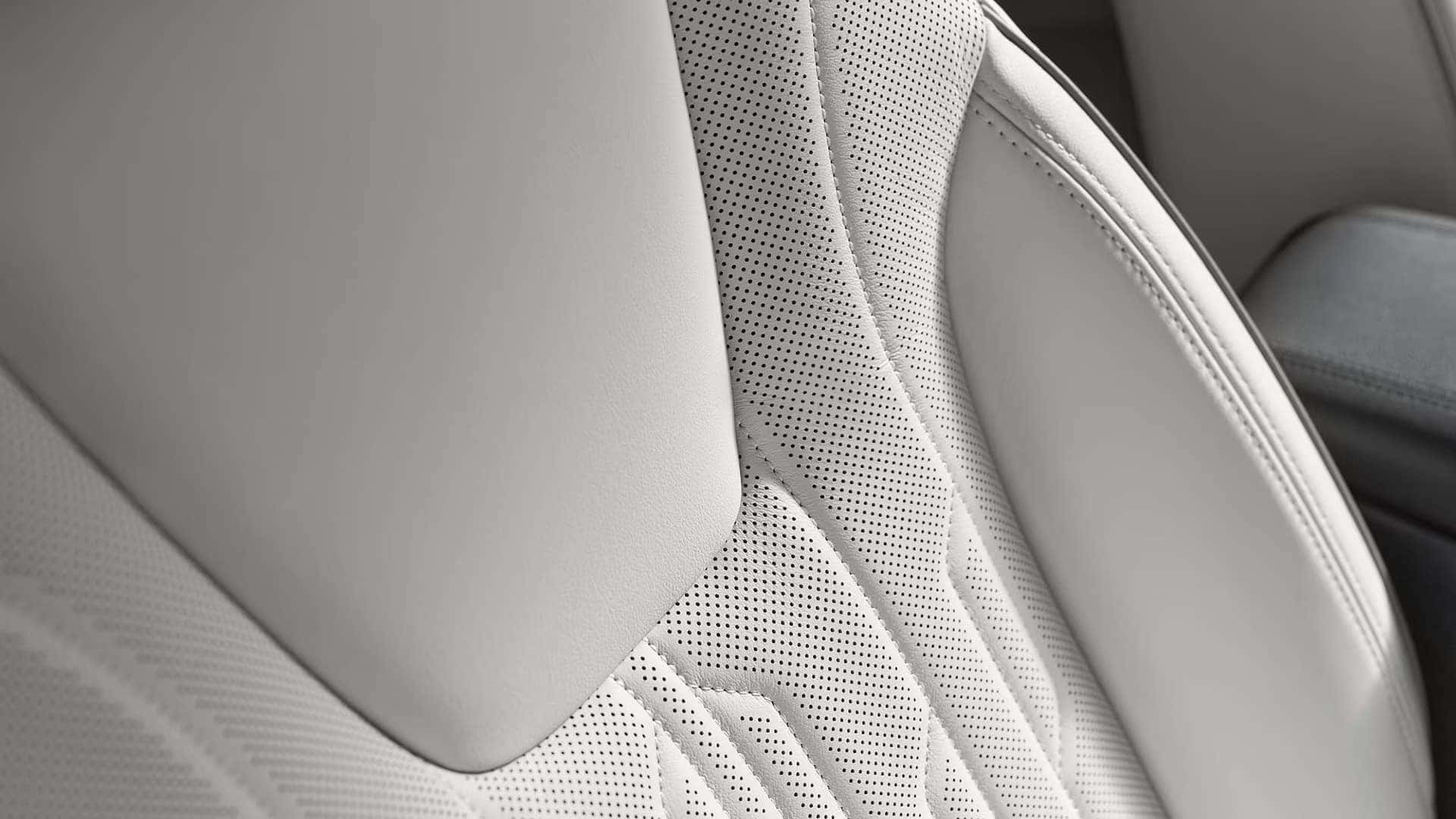 Close-up of light-colored perforated seating and detailed stitching in the 2026 Buick Encore GX Avenir