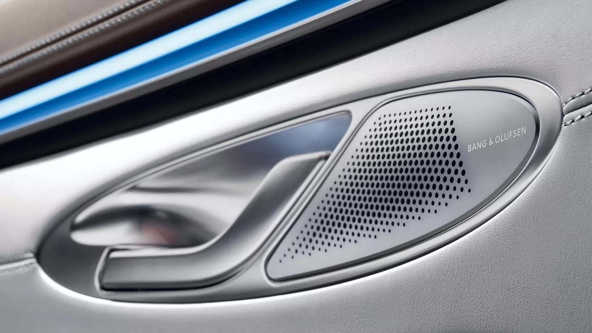 Bang & Olufsen speaker integrated into the 2026 Genesis Electrified GV70 front door panel with blue ambient lighting