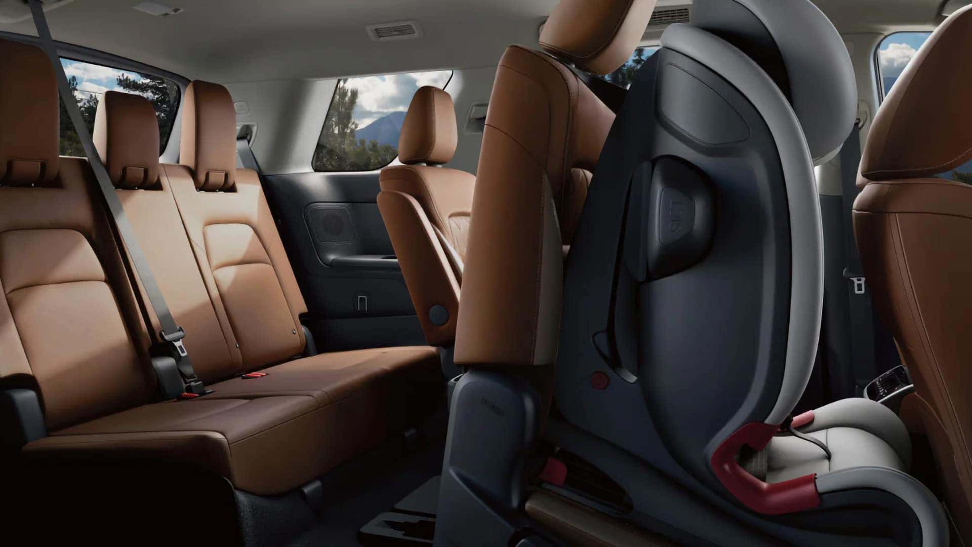 2026 Nissan Pathfinder three-row cabin with brown seats and a child safety seat in the second row