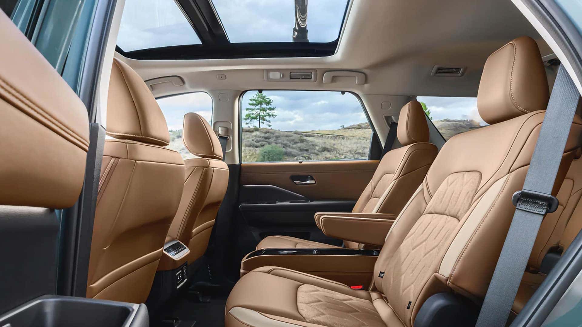2026 Nissan Pathfinder interior with brown captain’s chairs and a panoramic moonroof