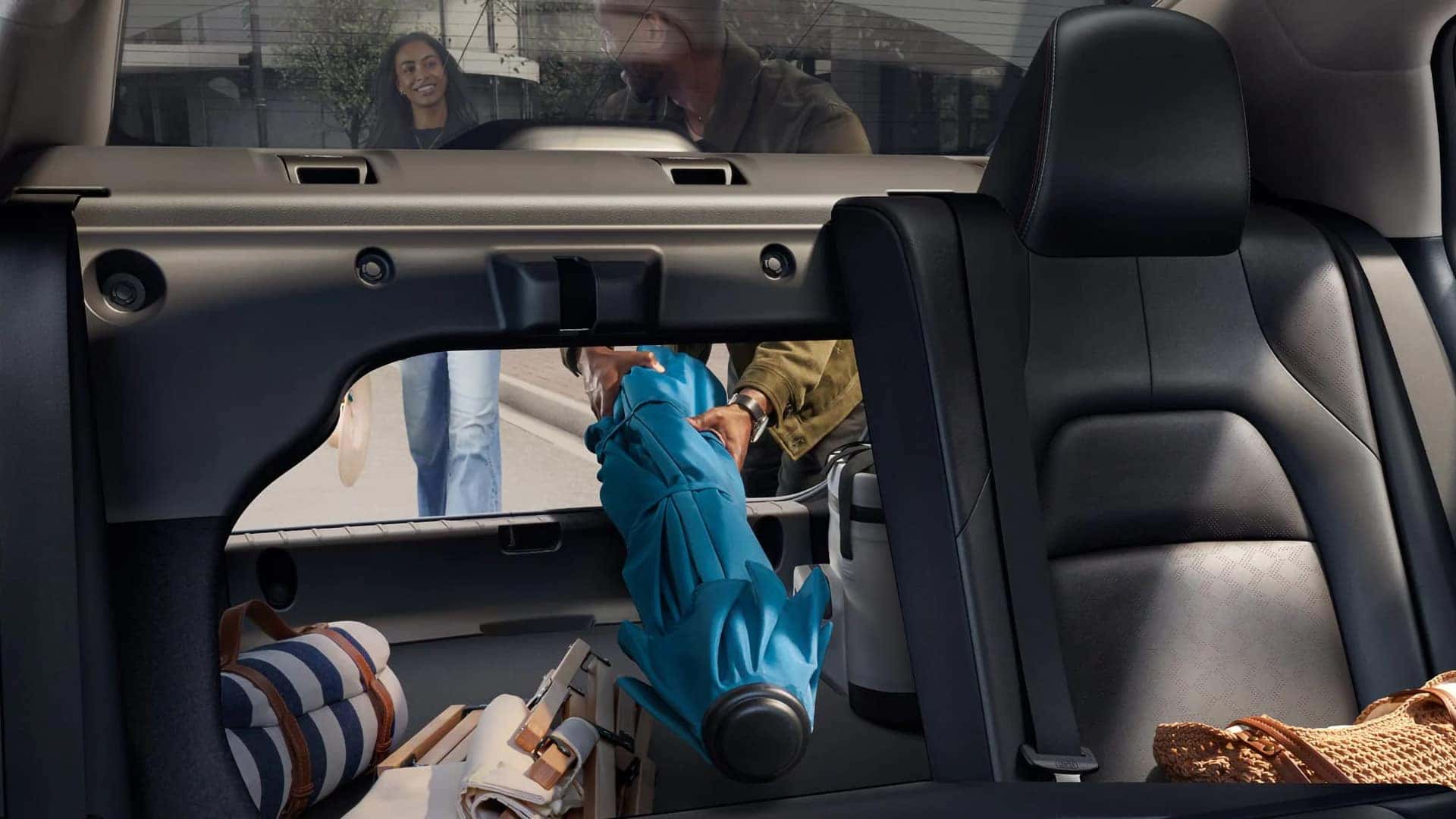 2026 Nissan Sentra pass-through trunk with a split-folding rear seat and cargo being loaded