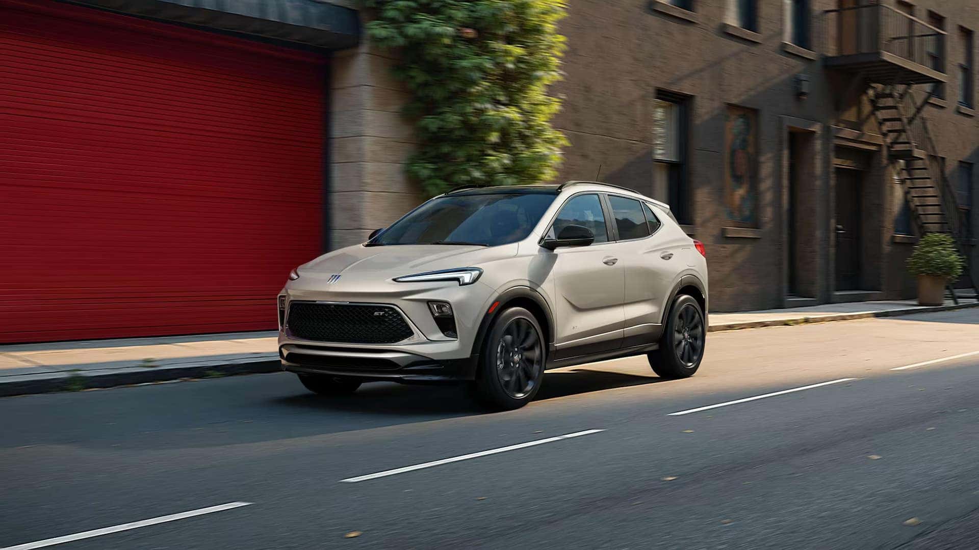 2026 Buick Encore GX Sport Touring driving along a city street