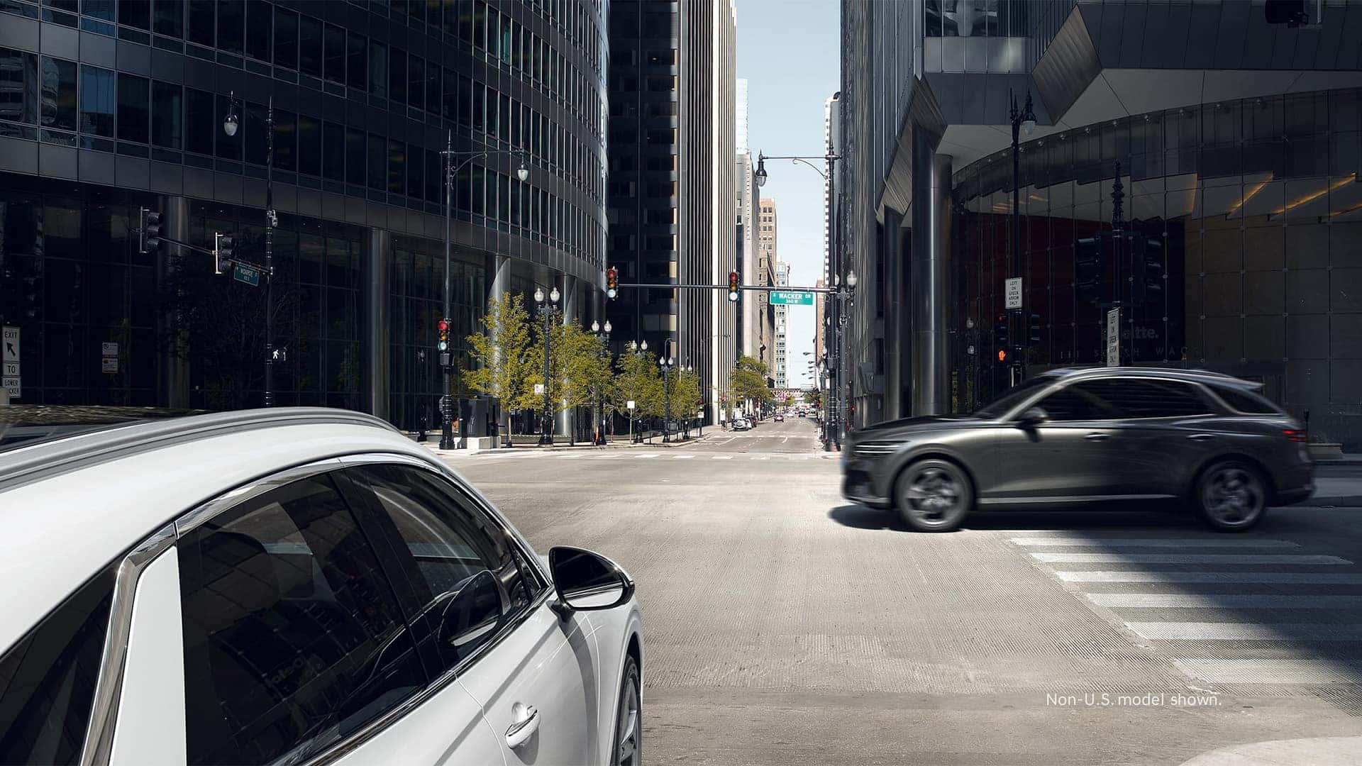 2026 Genesis Electrified GV70 approaching a city intersection with forward safety and collision avoidance technology