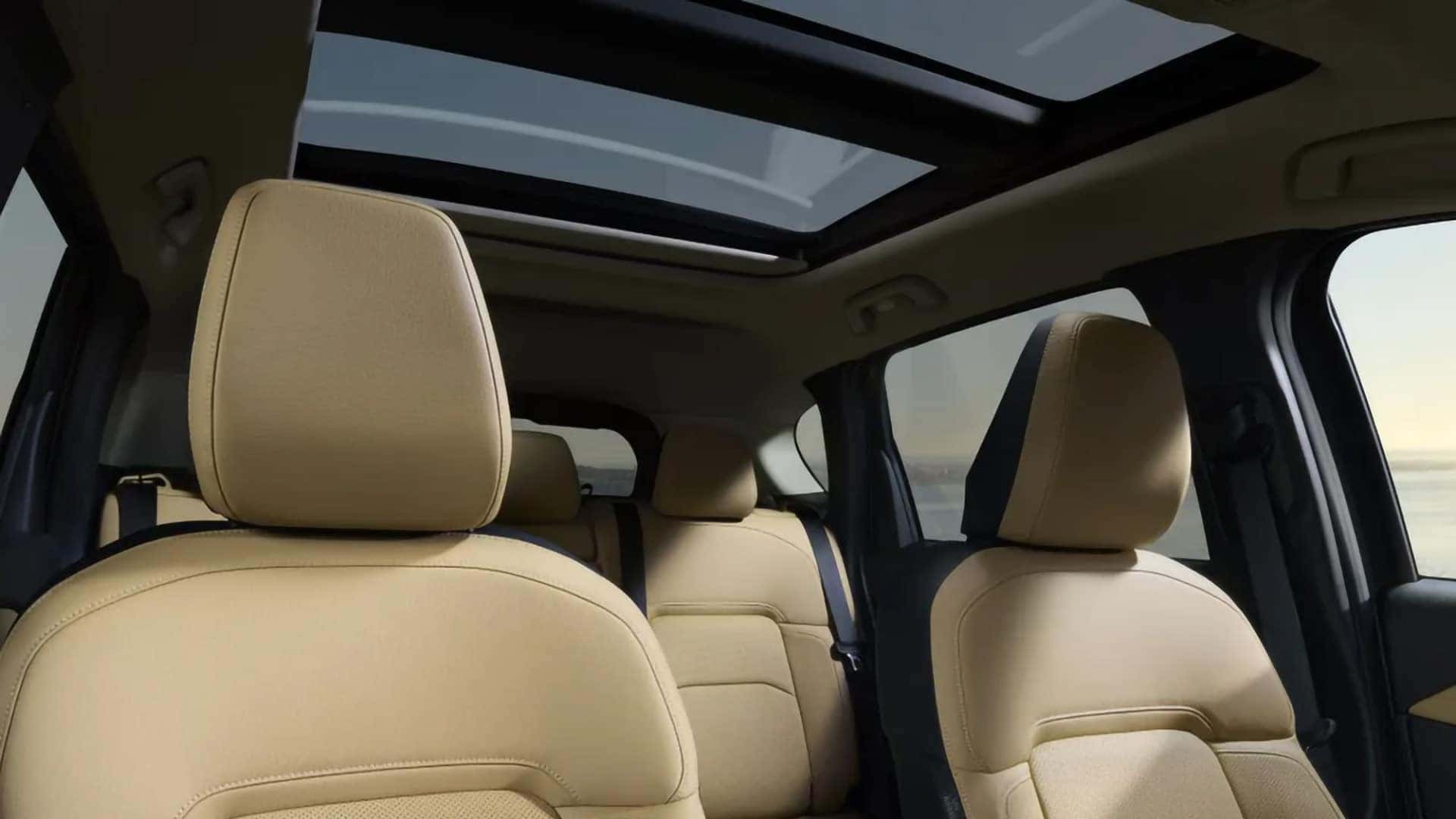 2026 Mazda CX-5 cabin with light-colored seating and an open power panoramic moonroof