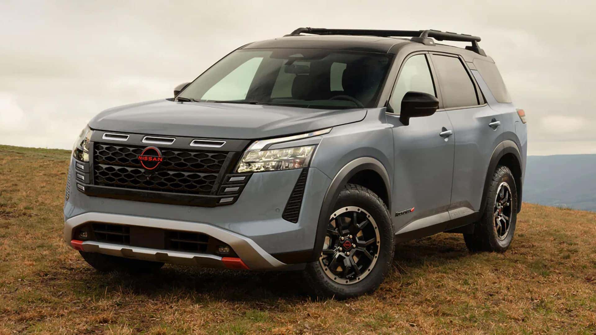 2026 Nissan Pathfinder Rock Creek with all-terrain tires, beadlock-style wheels, and tubular roof rack
