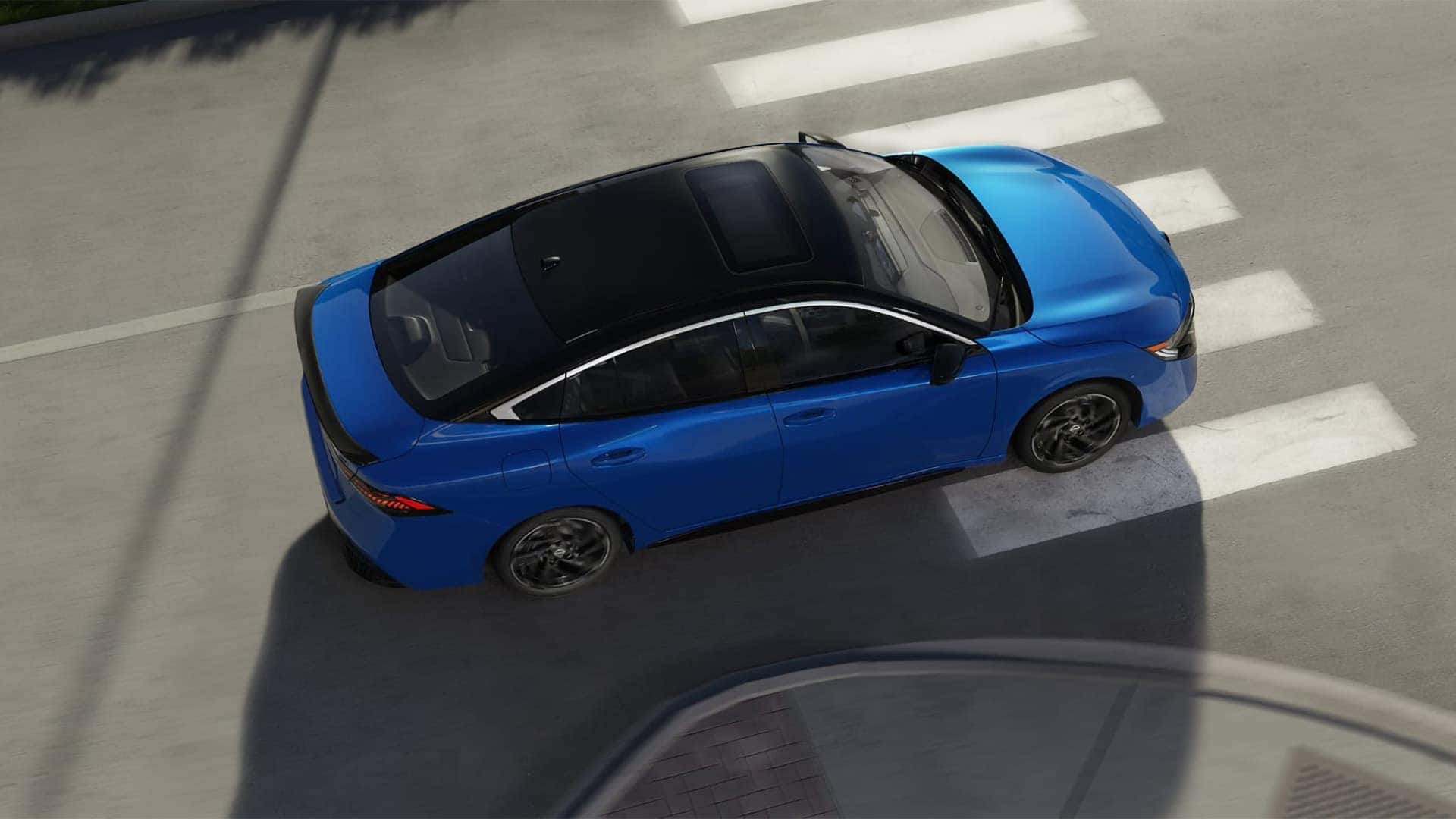 Overhead view of a blue 2026 Nissan Sentra showing its contrasting black roof and power sliding glass moonroof