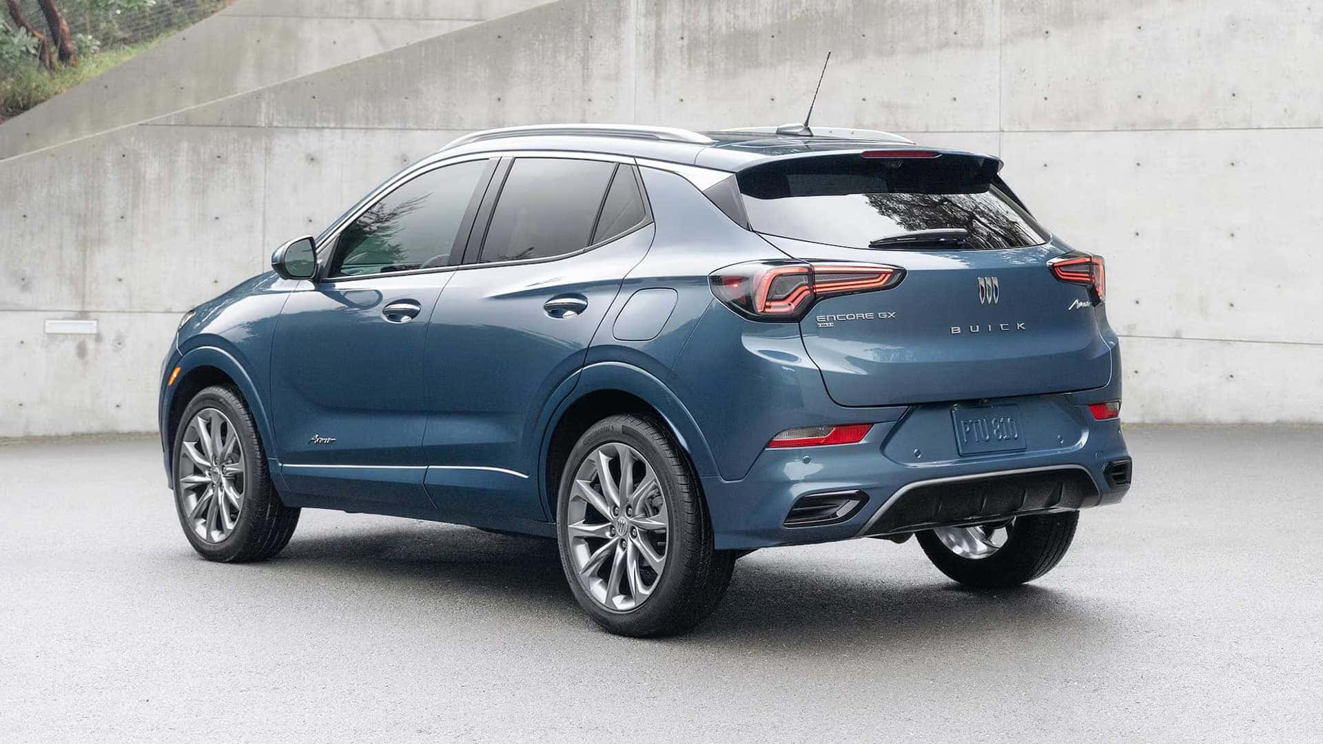 Blue 2026 Buick Encore GX Avenir in rear three-quarter view showing its sculpted body and taillamps