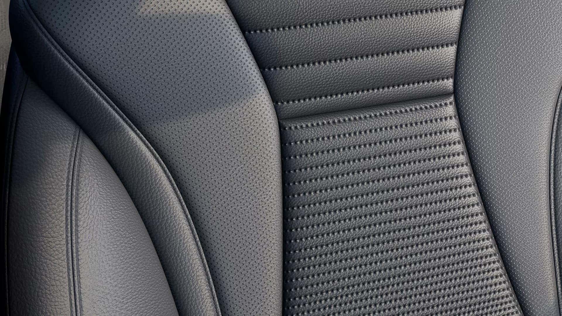 Close-up of black perforated upholstery and detailed stitching on a 2026 Buick Envision seat