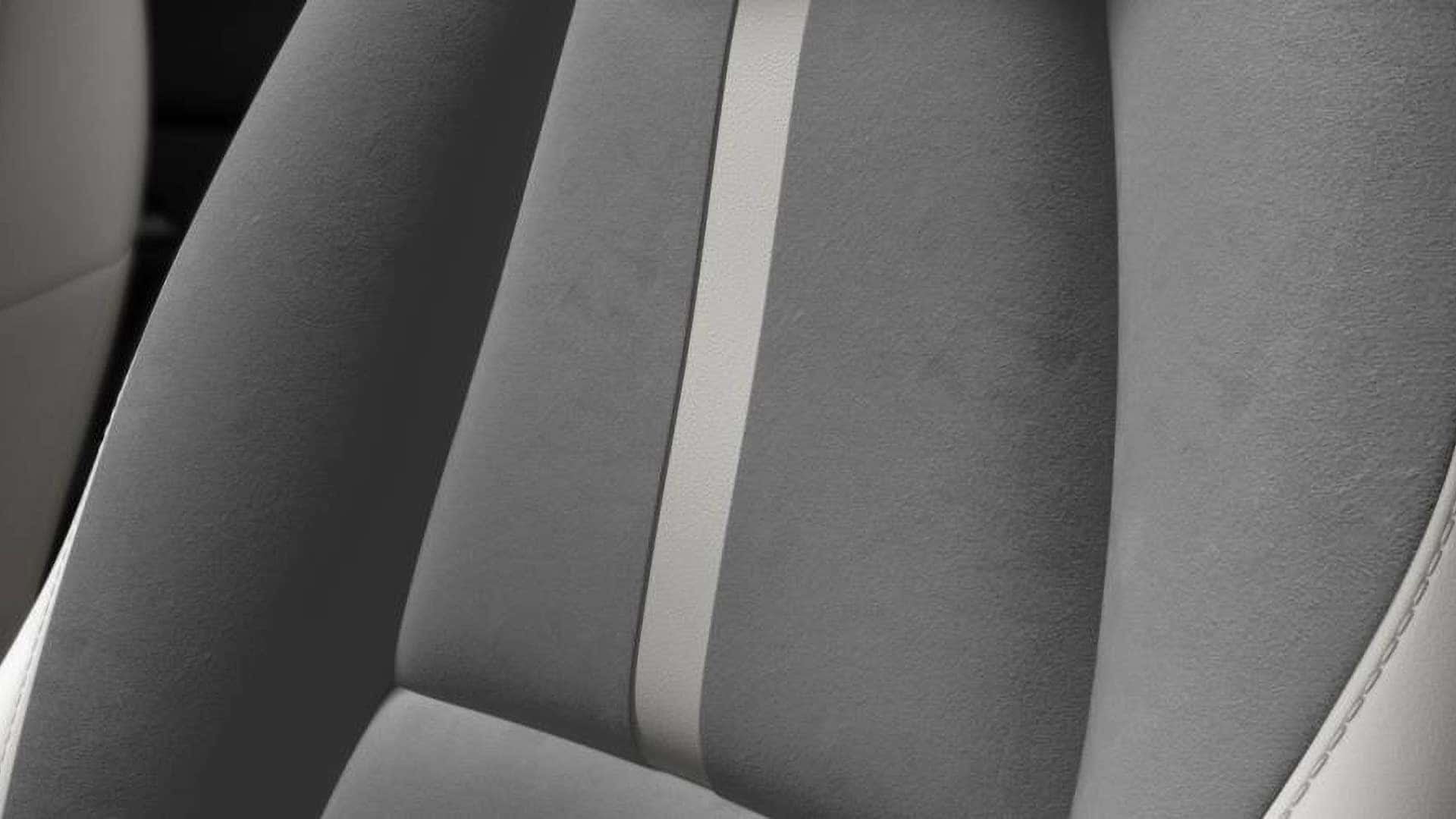 Close-up of light gray 2026 Mazda CX-30 seat upholstery with contrasting center stripe and stitching