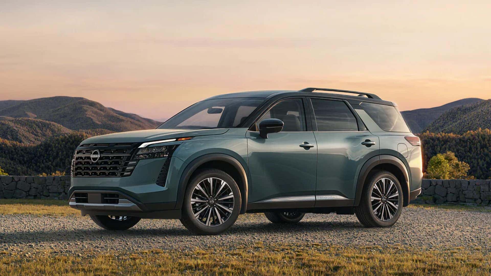 Green 2026 Nissan Pathfinder shown from the front and side at a scenic mountain overlook
