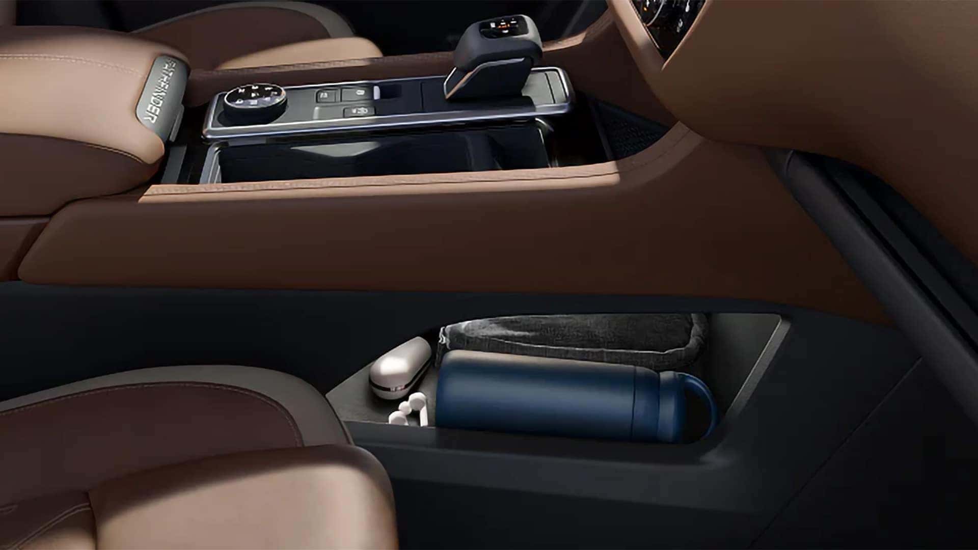 2026 Nissan Pathfinder center console with gear selector and open lower storage area for personal items