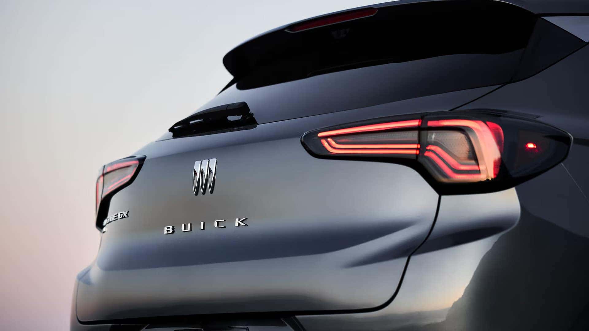 Rear of a 2026 Buick Encore GX with illuminated LED taillamps and Buick badging