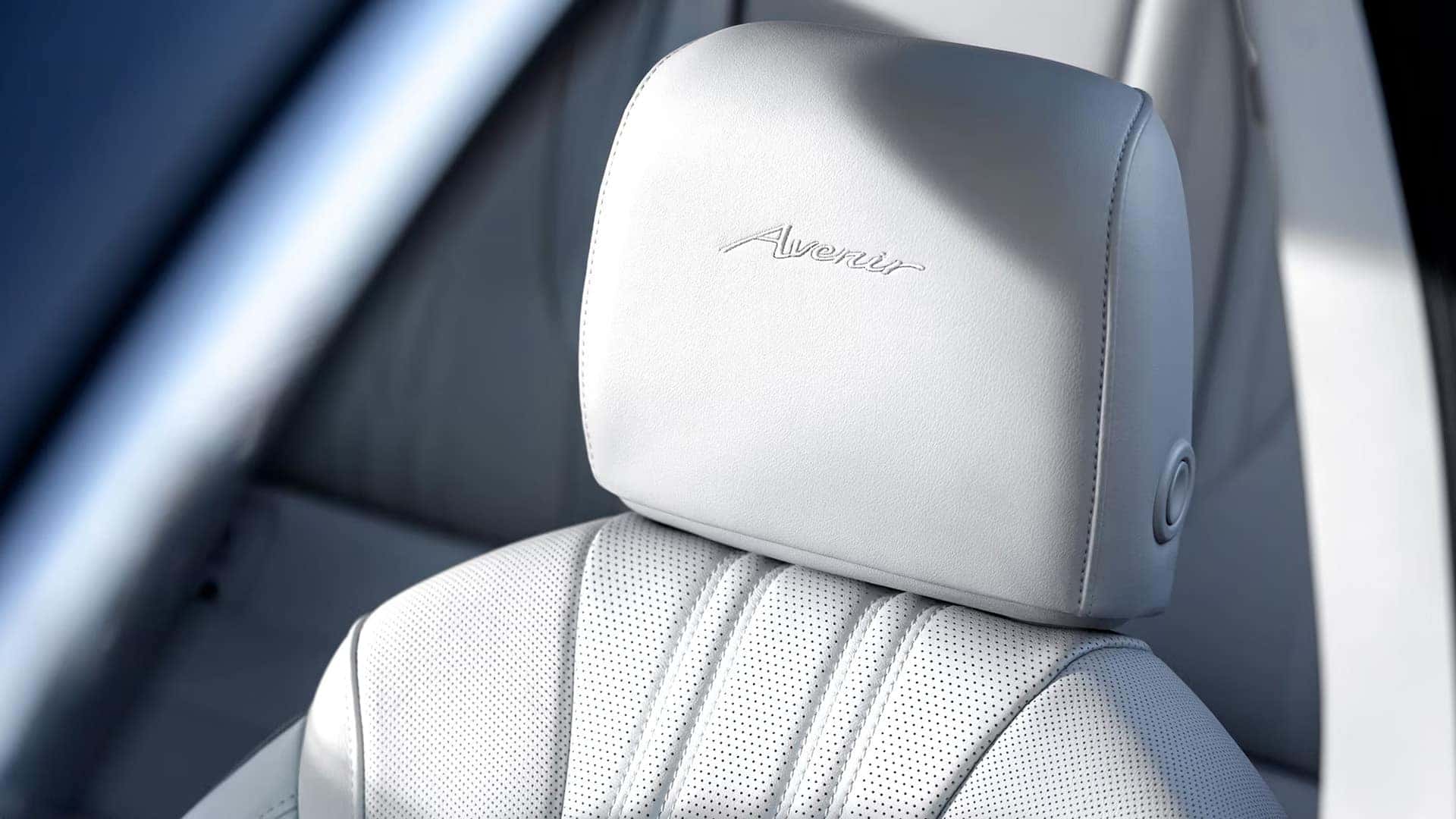 Light-colored perforated front seat with embroidered Avenir logo in the 2026 Buick Envision Avenir