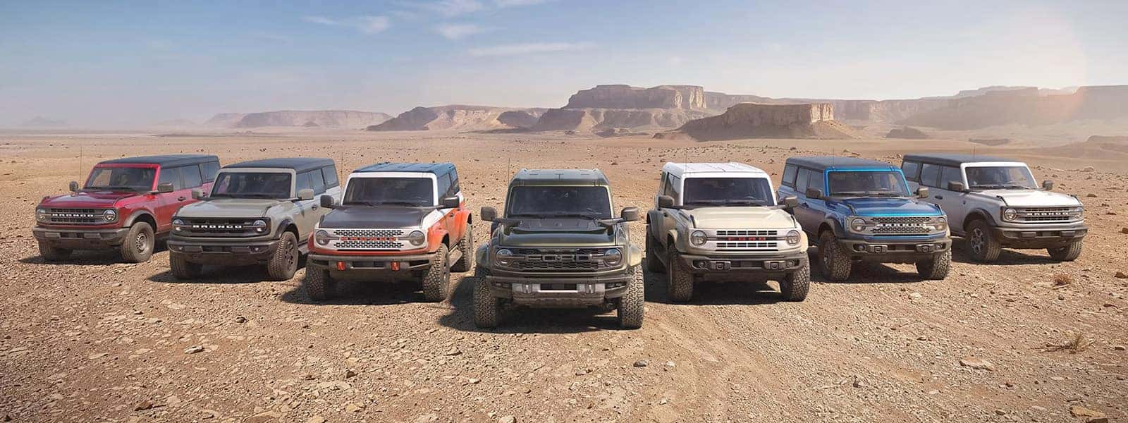 Seven 2026 Ford Bronco models lined up in a desert landscape