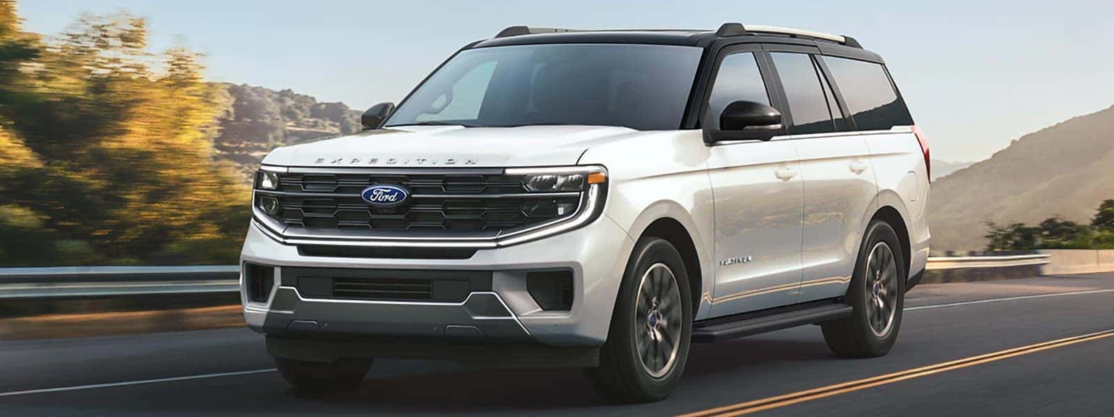 White 2026 Ford Expedition Platinum driving on a mountain road