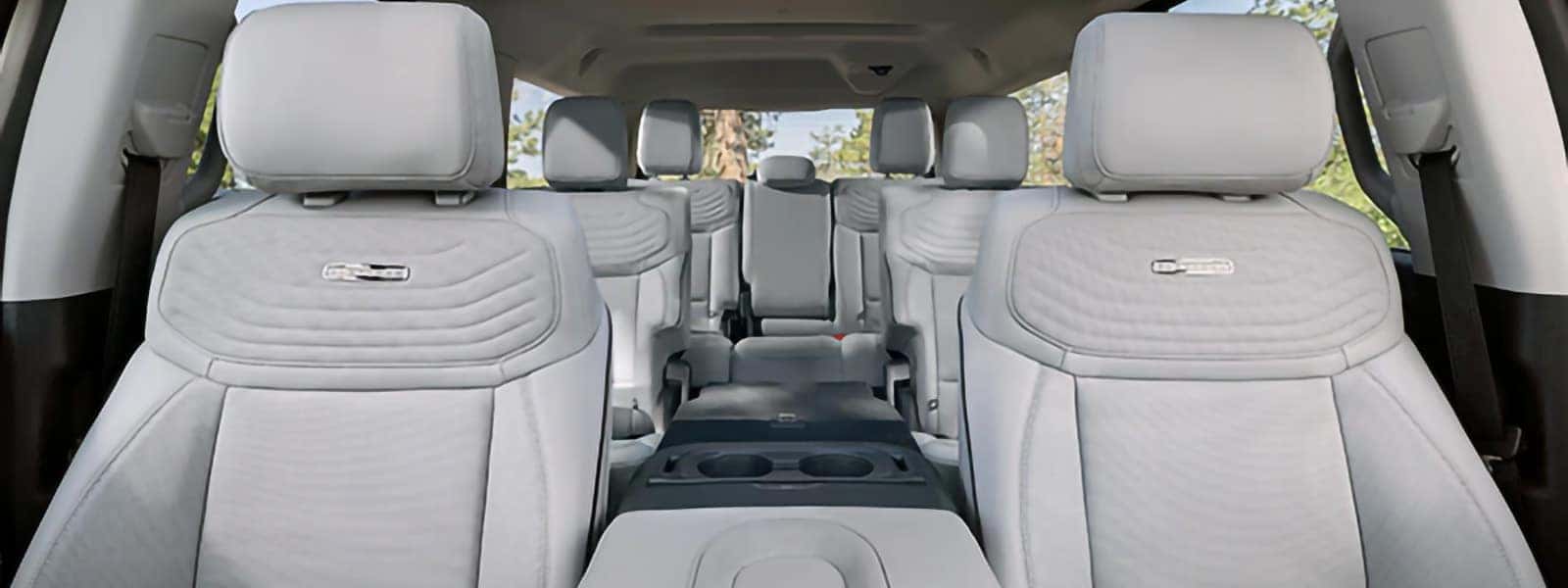 2026 Ford Expedition interior with three-row seating, light-colored seats, and center console