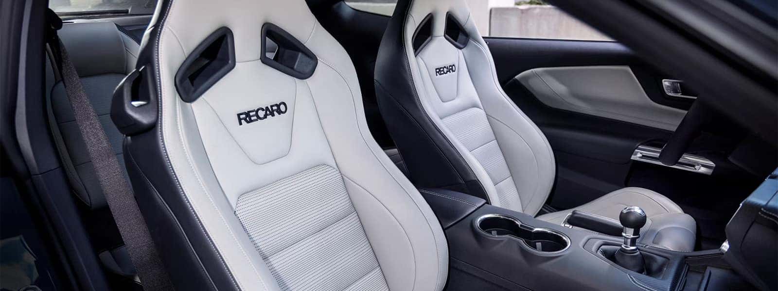 2026 Ford Mustang interior with white RECARO front seats and manual transmission