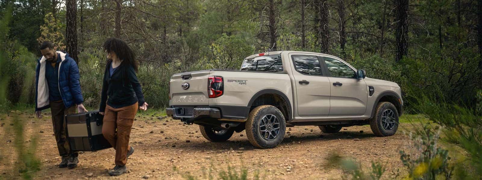 2026 Ford Ranger pickup parked on a wooded trail with outdoor gear