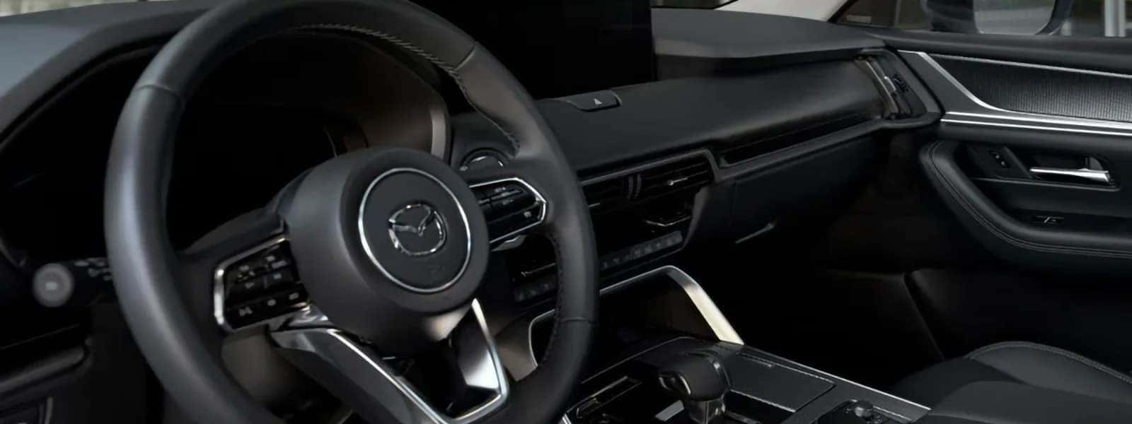 2026 Mazda CX-70 PHEV interior with steering wheel, digital displays, and center console