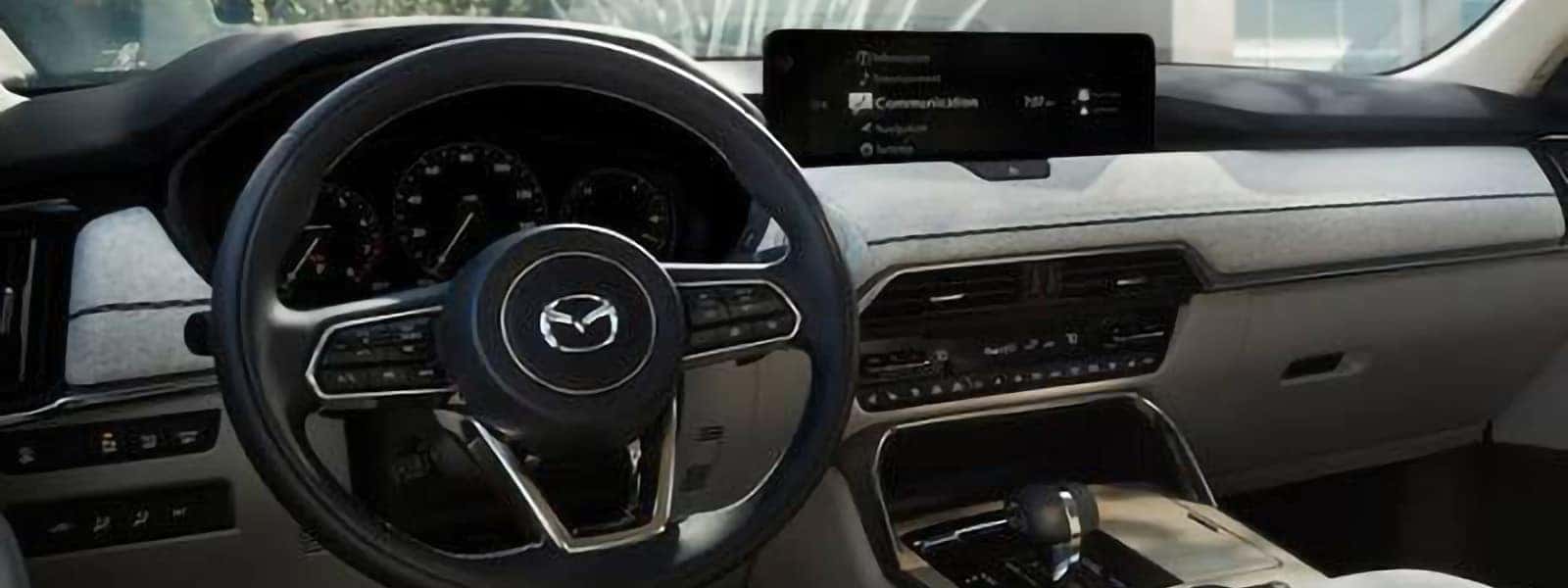 2026 Mazda CX-90 PHEV interior with steering wheel, digital gauge cluster, and Mazda Connect display
